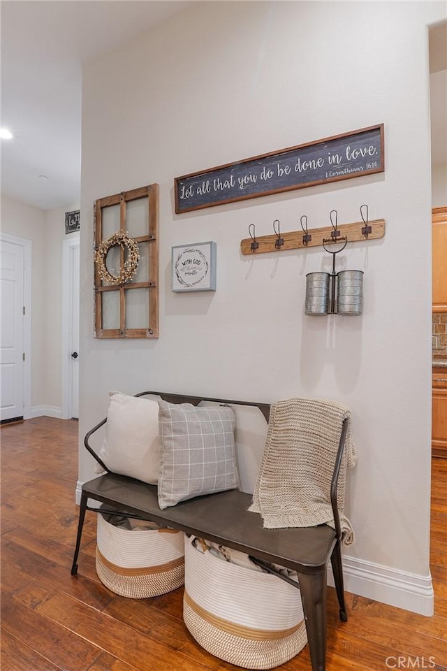 living area featuring baseboards and wood finished floors