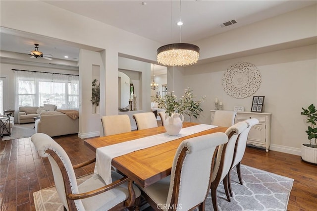 dining area featuring ceiling fan with notable chandelier, recessed lighting, baseboards, dark wood-type flooring, and visible vents