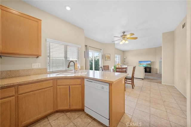 kitchen featuring a ceiling fan, visible vents, dishwasher, a sink, and a peninsula