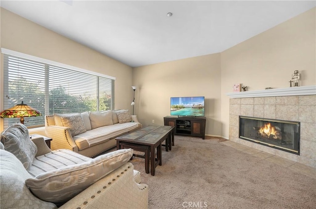 living room with carpet flooring and a tile fireplace
