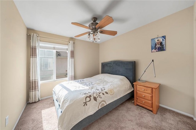 carpeted bedroom with baseboards and ceiling fan