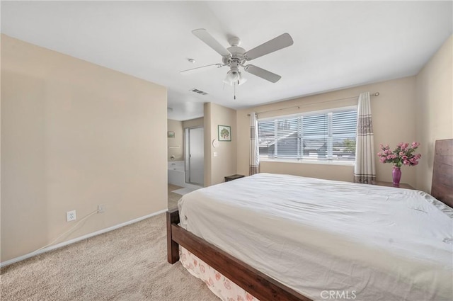 bedroom with visible vents, baseboards, a ceiling fan, carpet, and ensuite bath