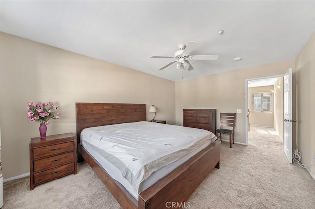 bedroom with baseboards, a ceiling fan, and light colored carpet