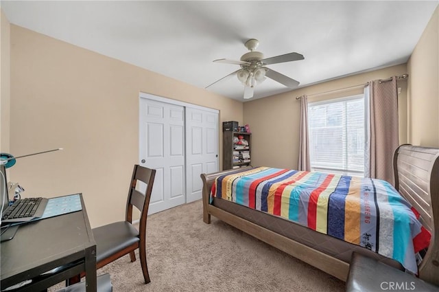 carpeted bedroom with a closet and ceiling fan