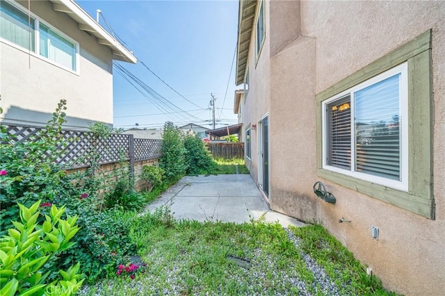 view of property exterior featuring a patio, a fenced backyard, and stucco siding