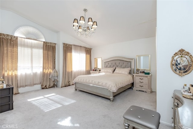 bedroom featuring an inviting chandelier, carpet floors, and lofted ceiling