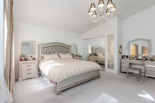 bedroom with a closet, light carpet, vaulted ceiling, and a notable chandelier