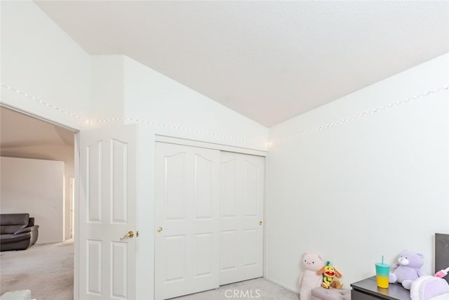 recreation room featuring vaulted ceiling and light carpet