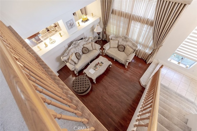 living area featuring baseboards and wood finished floors