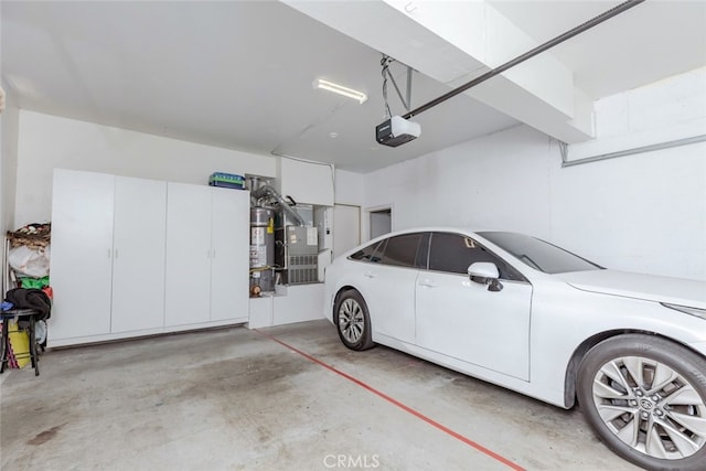 garage featuring secured water heater, heating unit, and a garage door opener