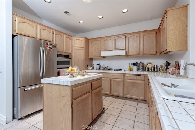 kitchen featuring visible vents, light tile patterned floors, light brown cabinets, tile counters, and stainless steel appliances