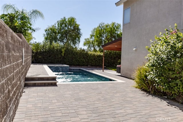 view of pool with a fenced in pool, a patio area, fence, and an in ground hot tub