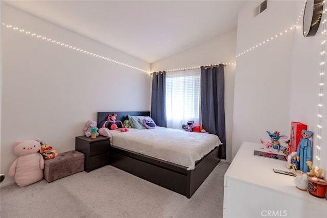 bedroom featuring vaulted ceiling, light colored carpet, and visible vents