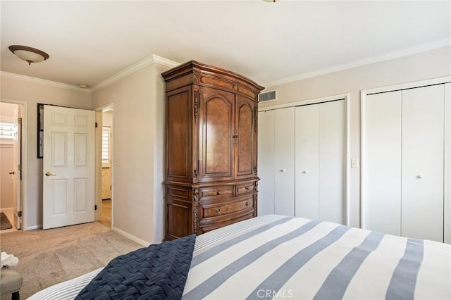 bedroom with light carpet, two closets, baseboards, visible vents, and ornamental molding