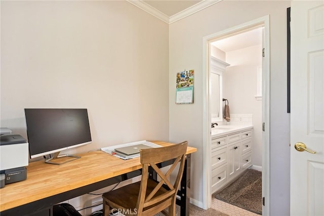 carpeted home office with crown molding, baseboards, and a sink