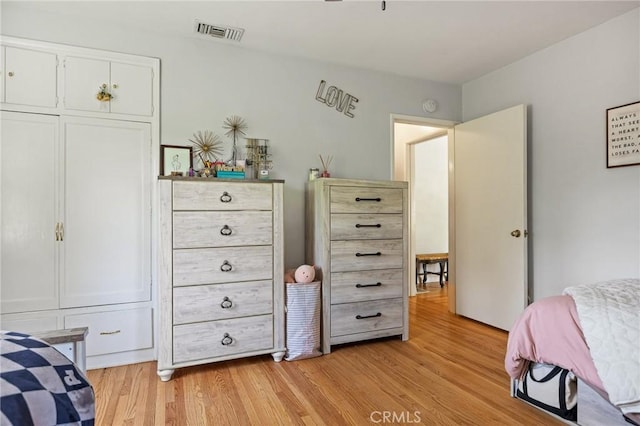 bedroom with visible vents and light wood-style flooring