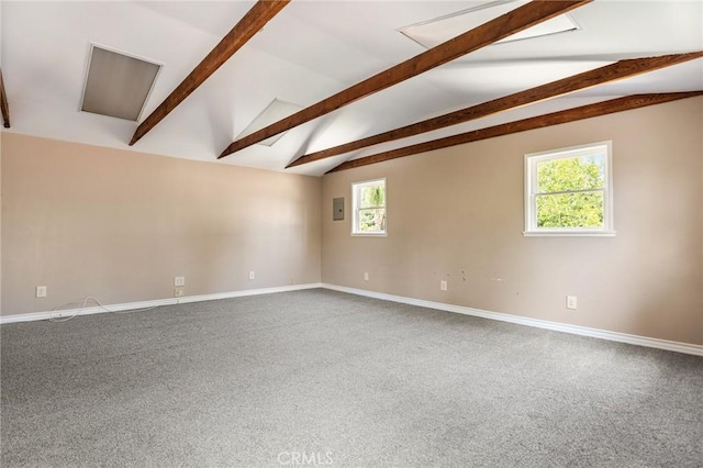 spare room with carpet floors, baseboards, and vaulted ceiling with beams