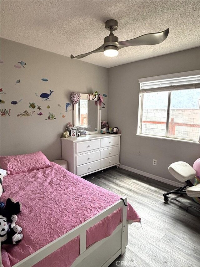 6845 Butte Dr, Riverside, CA 92505 - bedroom with wood finished floors, a textured ceiling, baseboards, and a ceiling fan