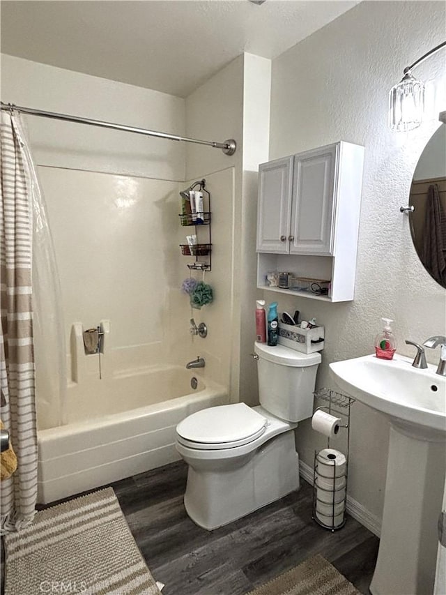 6845 Butte Dr, Riverside, CA 92505 - full bathroom with toilet, wood finished floors, shower / tub combo, a textured wall, and baseboards