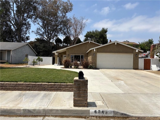 6845 Butte Dr, Riverside, CA 92505 - view of front of house with an attached garage, stucco siding, and driveway