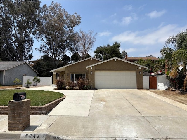6845 Butte Dr, Riverside, CA 92505 - ranch-style home with driveway, a garage, and stucco siding