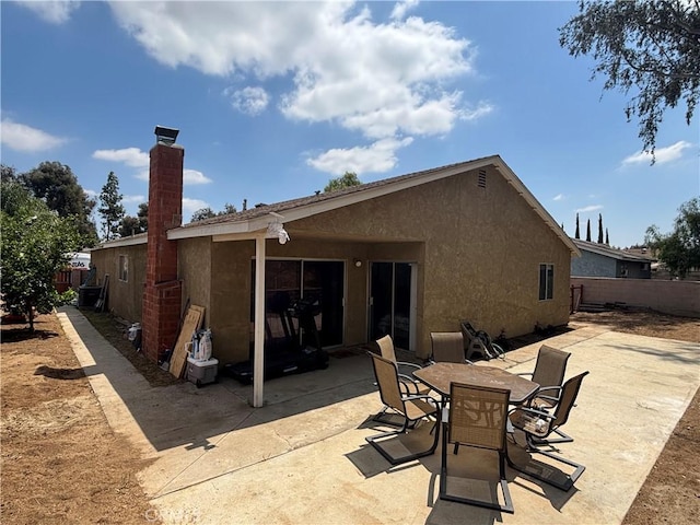 6845 Butte Dr, Riverside, CA 92505 - back of property featuring a patio, stucco siding, a chimney, and outdoor dining area