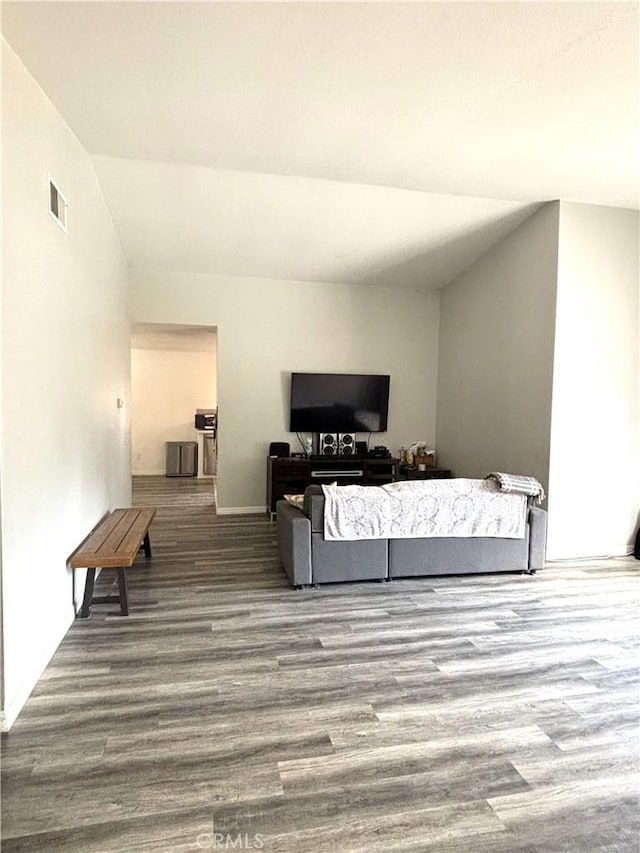 6845 Butte Dr, Riverside, CA 92505 - living area featuring vaulted ceiling, wood finished floors, and baseboards