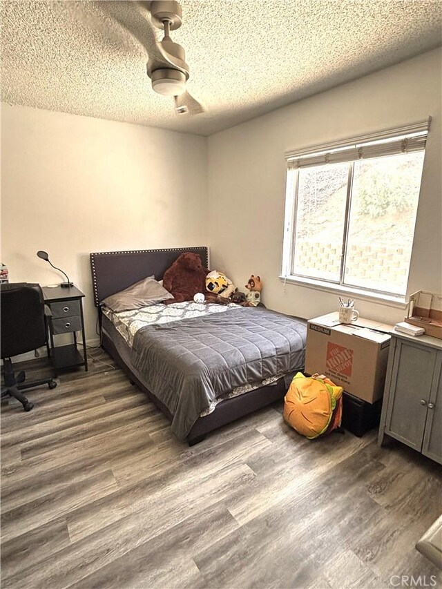 6845 Butte Dr, Riverside, CA 92505 - bedroom featuring wood finished floors and a textured ceiling
