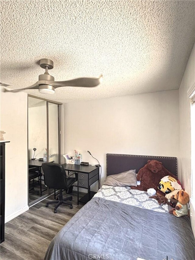 6845 Butte Dr, Riverside, CA 92505 - bedroom with a textured ceiling, wood finished floors, ceiling fan, and a desk