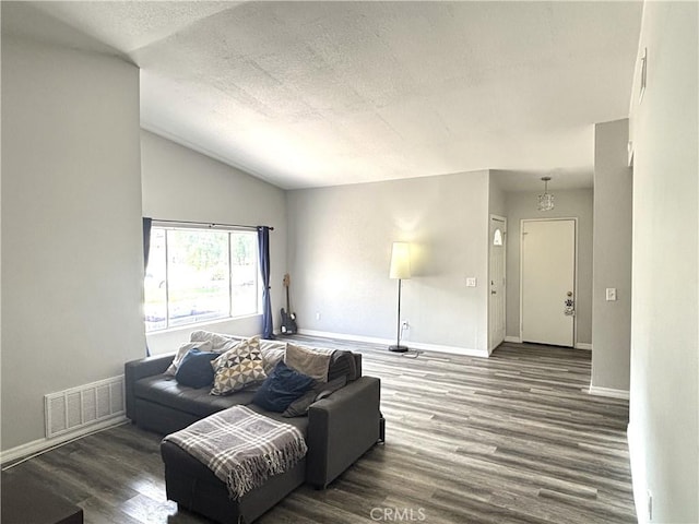 6845 Butte Dr, Riverside, CA 92505 - living area featuring wood finished floors, vaulted ceiling, baseboards, and a textured ceiling