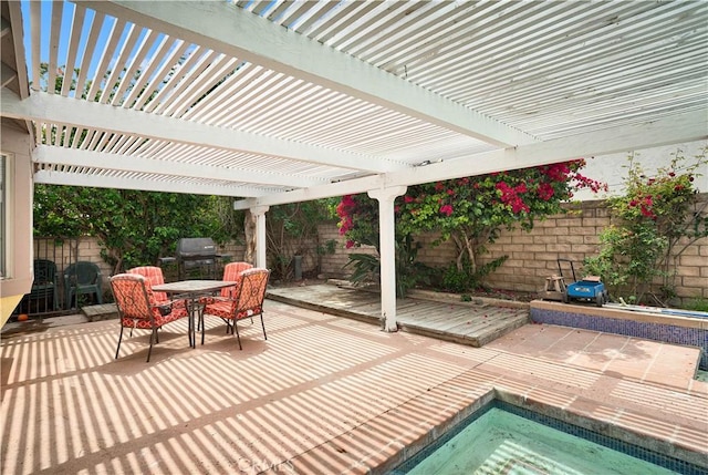 view of patio / terrace featuring outdoor dining area, a fenced backyard, an in ground hot tub, and grilling area