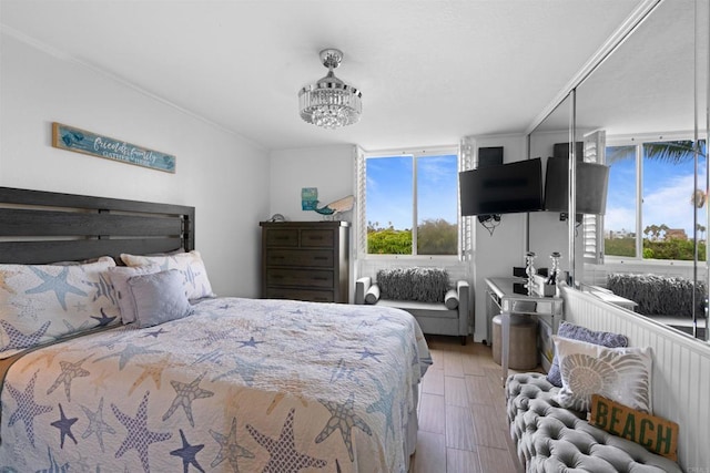 bedroom featuring multiple windows and wood finished floors