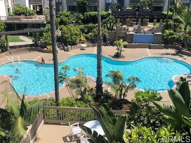 pool featuring fence and a patio area