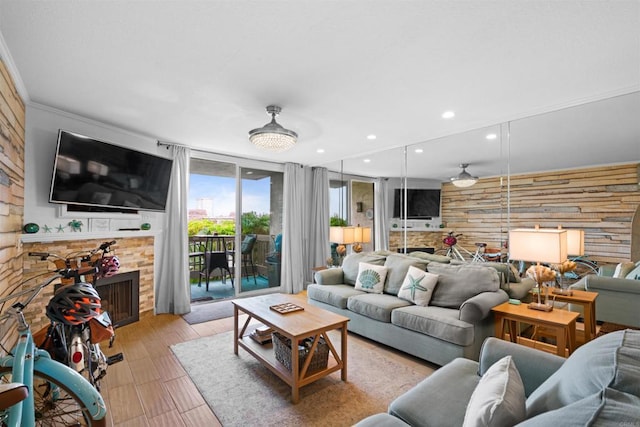 living area featuring recessed lighting, wood walls, and a fireplace
