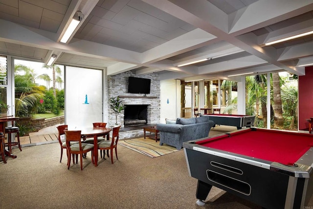 game room featuring carpet floors, pool table, beamed ceiling, and a stone fireplace
