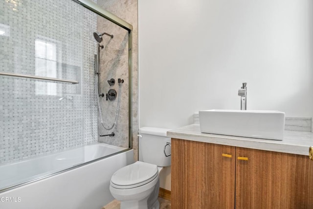 bathroom with bath / shower combo with glass door, vanity, and toilet