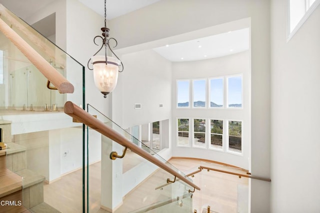 stairs with recessed lighting and a high ceiling