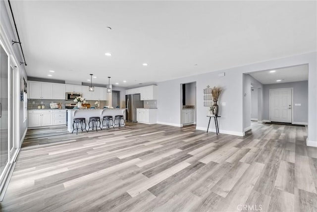 20372 Crooked Branch St, Riverside, CA 92507 - unfurnished living room featuring recessed lighting, light wood-style flooring, and baseboards