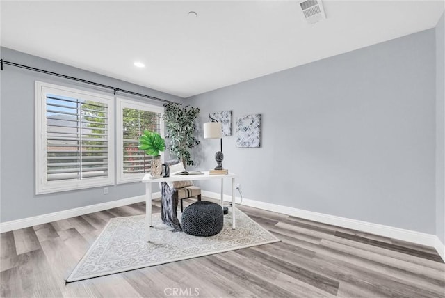 office featuring baseboards, wood finished floors, and recessed lighting