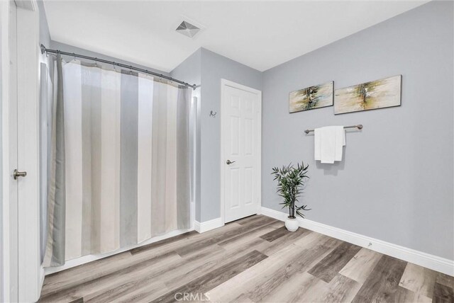 20372 Crooked Branch St, Riverside, CA 92507 - full bathroom with wood finished floors, baseboards, and a shower with curtain