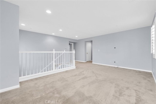 carpeted empty room with baseboards and recessed lighting