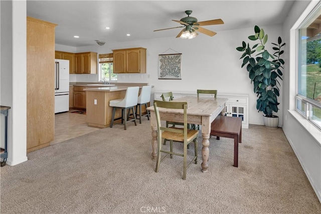 dining space with ceiling fan, light carpet, and recessed lighting
