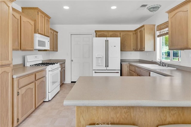 9121 San Diego Rd, Atascadero, CA 93422 - kitchen with white appliances, a peninsula, recessed lighting, light countertops, and light flooring