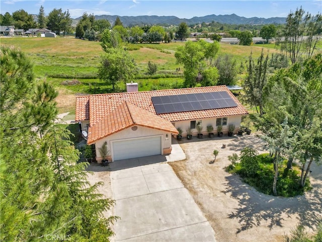 birds eye view of property with a mountain view and a rural view
