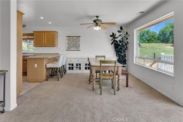 dining space featuring plenty of natural light, a ceiling fan, recessed lighting, and light carpet