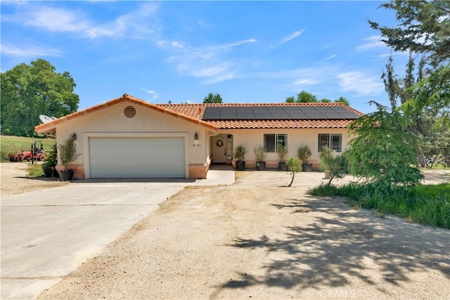 9121 San Diego Rd, Atascadero, CA 93422 - view of front of house featuring an attached garage, solar panels, concrete driveway, stucco siding, and a tile roof
