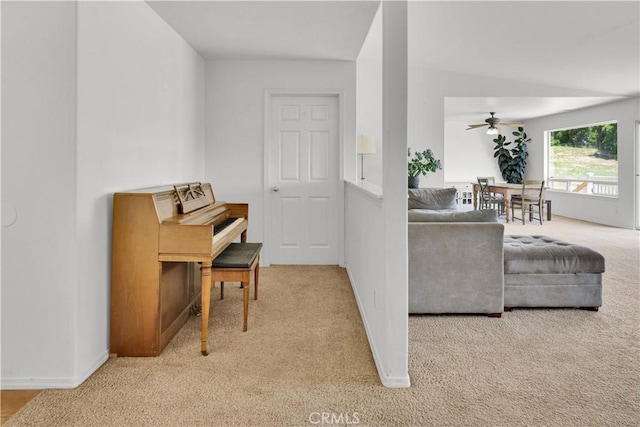 interior space featuring baseboards, carpet flooring, and a ceiling fan