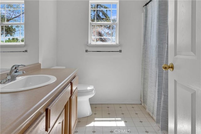 full bath featuring vanity, tile patterned flooring, toilet, baseboards, and a shower with shower curtain