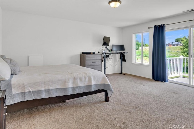 carpeted bedroom with access to outside, baseboards, visible vents, and multiple windows