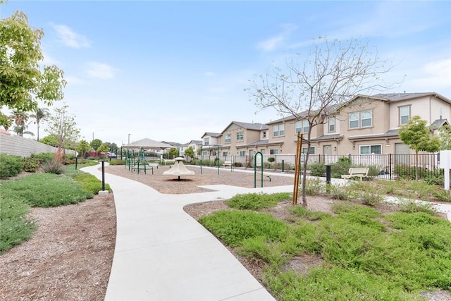 view of home's community featuring a residential view and fence